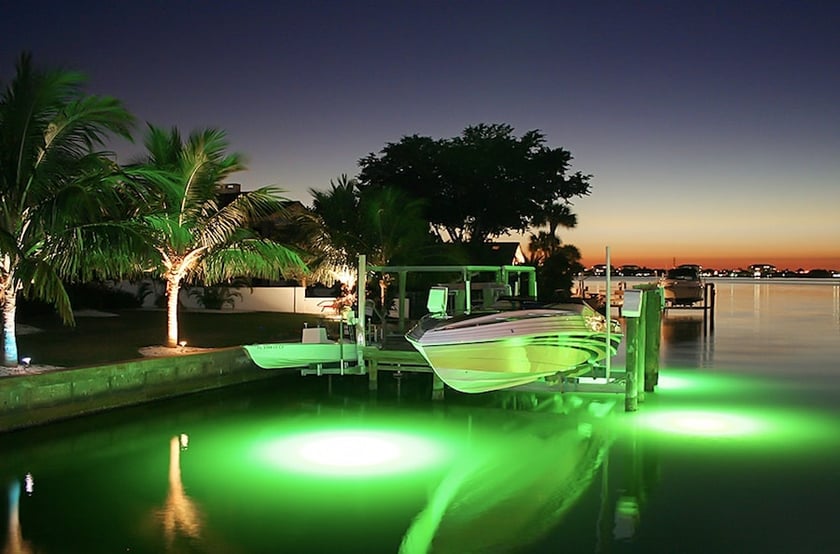 marine electrical lights in water by dock and boat and seawall