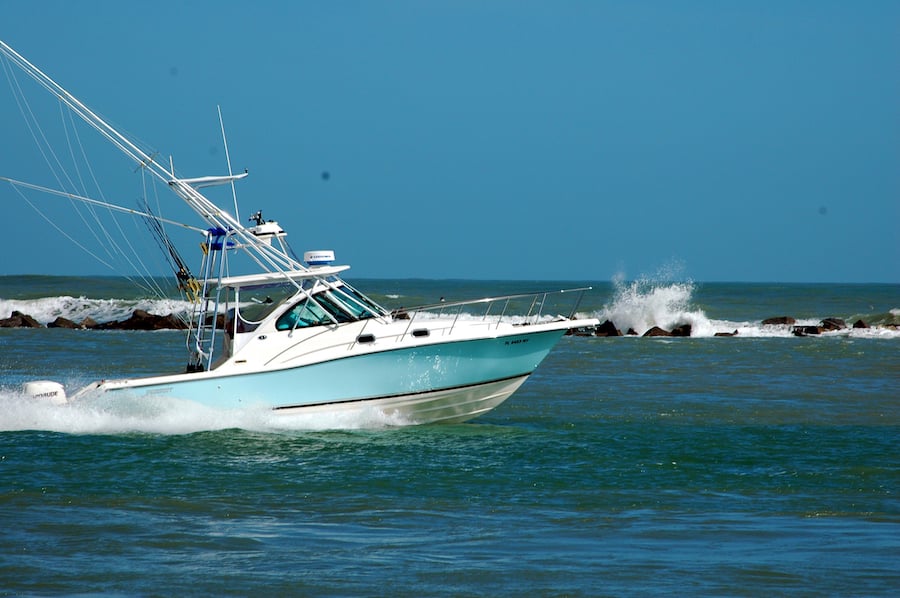 sport fishing convertable boat in blue waters ocean